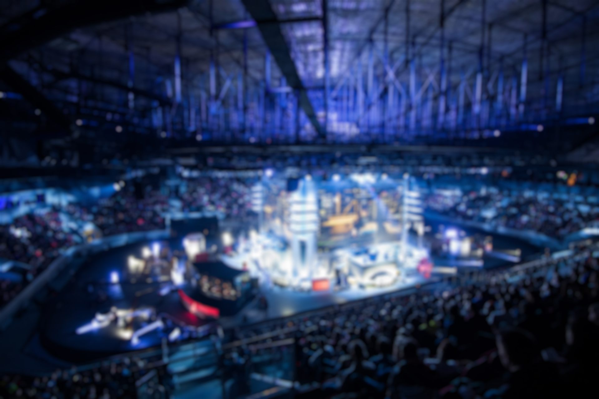 Blurred crowd in a large indoor arena at night